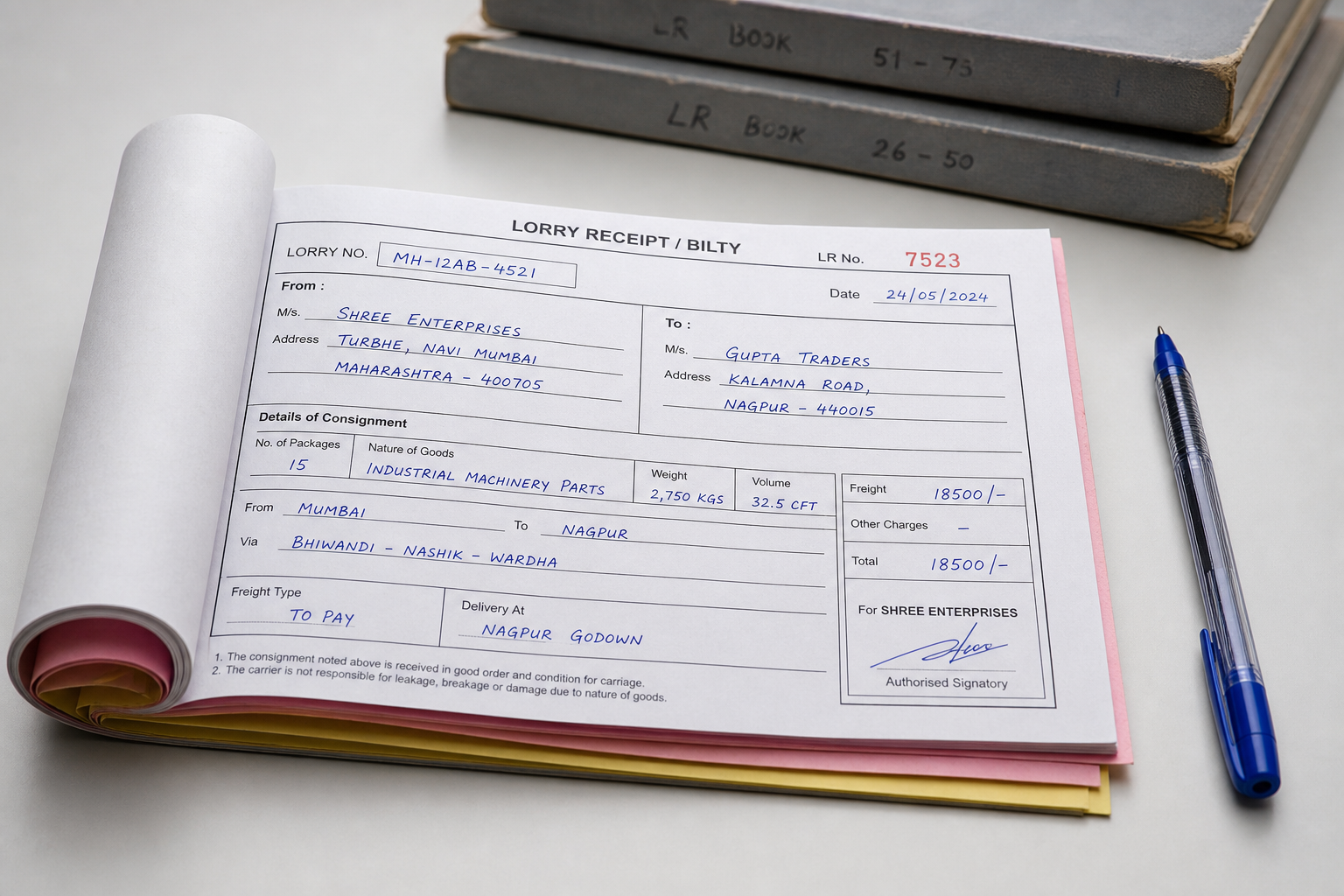 Open handwritten carbon bilty book with LR registers on a transport office desk